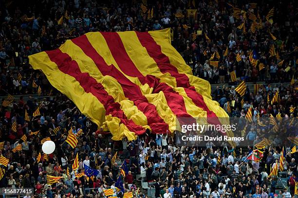 Supporters of the Pro-Independence Catalan party Convergence and Union display a huge Catalan flag during the closing rally ahead of Catalan...