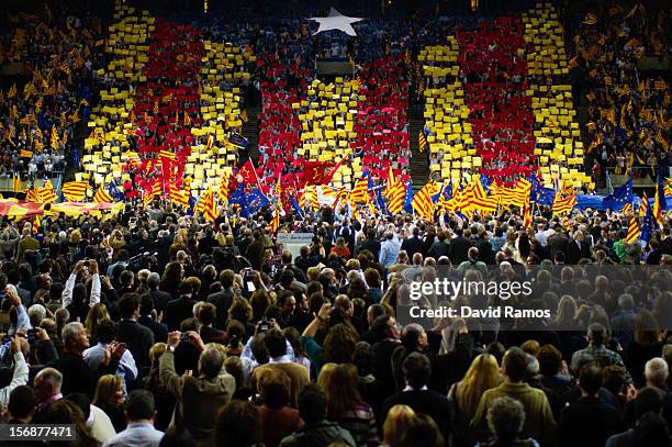 Supporters of the Pro-independence Catalan party Convergence and Union display a 'Estelada', the Pro-Independence Catalonia's flag, during the...
