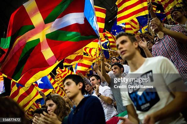 Supporters of the Pro-independence Catalan party Convergence and Union fly a Basque Country flag among Catalan and European flags during the closing...