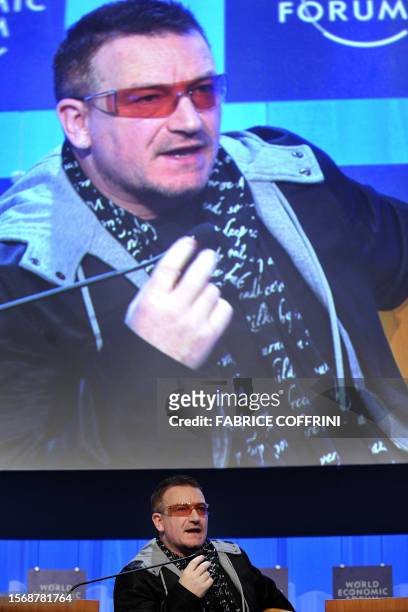 Irish rocker Bono talks during a session with former US vice president and Nobel laureate Al Gore at the World Economic Forum in Davos in 24 January...