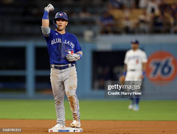 Daulton Varsho of the Toronto Blue Jays celebrates his two run double, to take a 5-3 lead over the Los Angeles Dodgers during the 11th innin at...