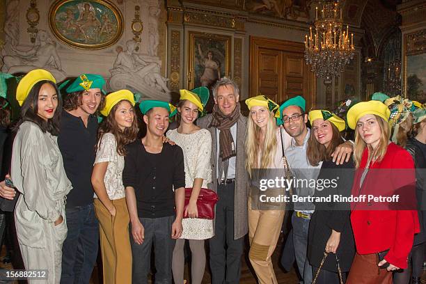 Geoffroy de la Bourdonnaye , CEO of Chloe fashion house, poses with young employees of Chloe at the Paris City Hall during the Sainte-Catherine...
