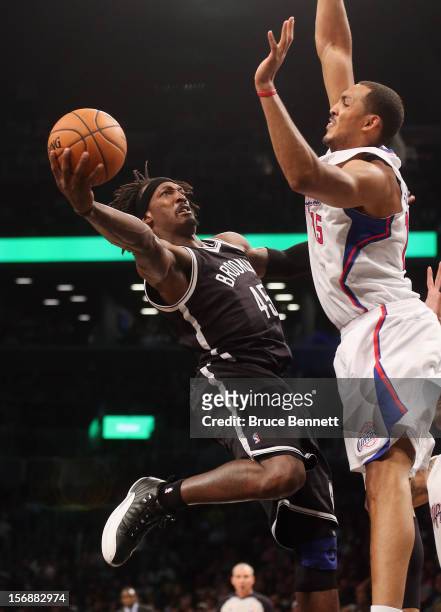 Gerald Wallace of the Brooklyn Nets scores two past Ryan Hollins of the Los Angeles Clippers in the fourth quarter at the Barclays Center on November...