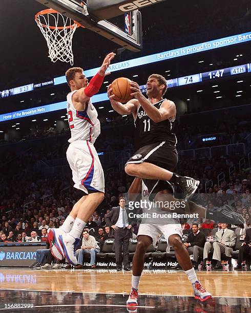 Brook Lopez of the Brooklyn Nets is blocked by Blake Griffin of the Los Angeles Clippers at the Barclays Center on November 23, 2012 in the Brooklyn...