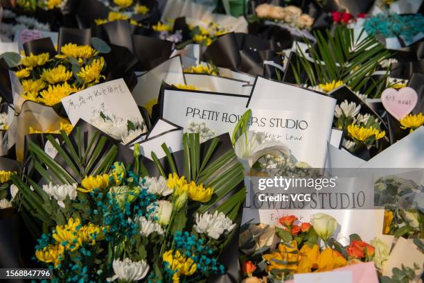 Flowers are laid outside No.34 Middle School to mourn for victims of gym roof collapse on July 25, 2023 in Qiqihar, Heilongjiang Province of China....