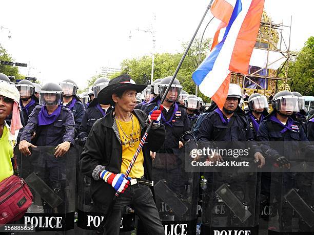 Thai anti government protester confronts riot police duringg an anti government protest on November 24, 2012 in Bangkok, Thailand. The Pitak Siam...