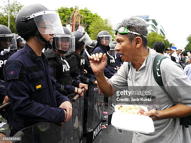 Thai anti government protester confronts riot police duringg an anti government protest on November 24, 2012 in Bangkok, Thailand. The Pitak Siam...