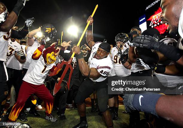 Running back Cameron Marshall of the Arizona State Sun Devils spikes the fork into the grass in celebration after defeating the Arizona Wildcats...