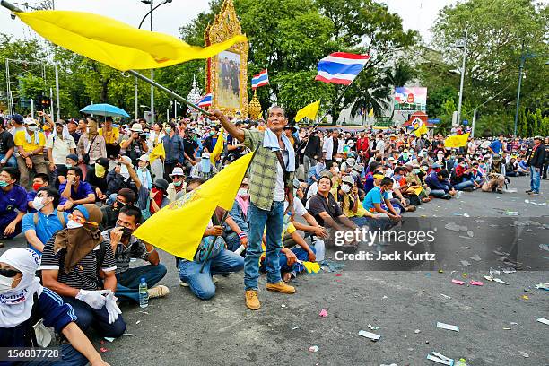 Anti-government protesters sit on the ground to face riot police during a large anti government protest on November 24, 2012 in Bangkok, Thailand....