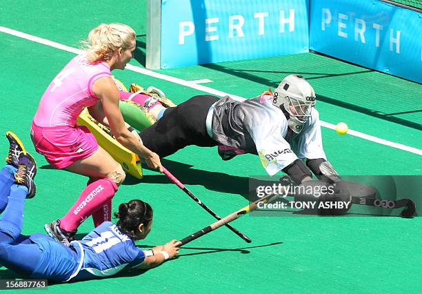 Nor Azlin Sumantri of Malaysia scores a diving goal as Casey Eastham and goalkeeper Ashlee Wells of Australia try to make a save during their women's...
