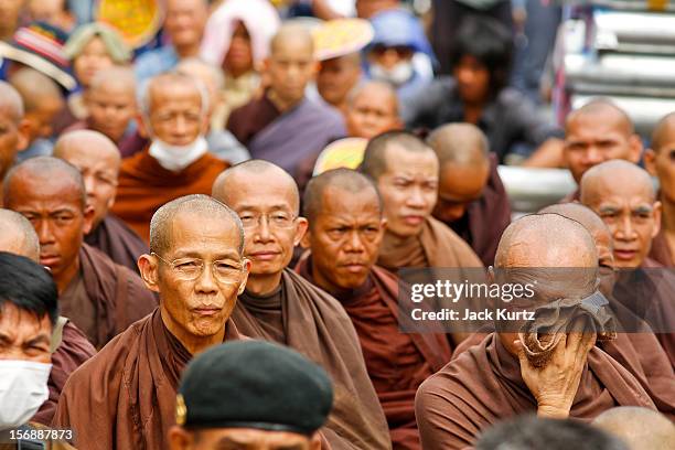 Buddhist monks sit on the ground in front of riot police during a large anti government protest on November 24, 2012 in Bangkok, Thailand. The Siam...