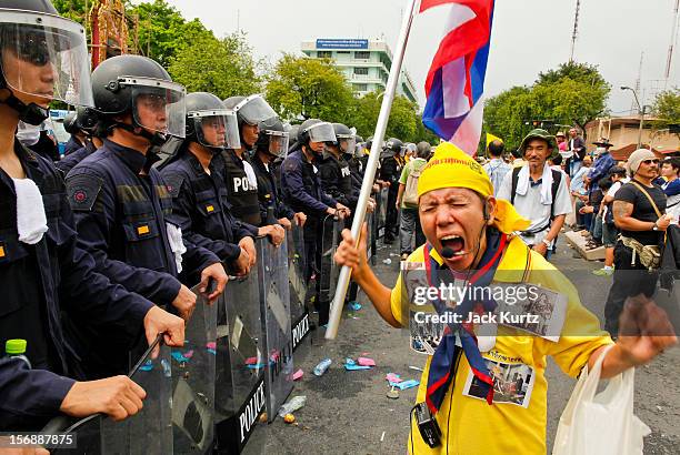 Thai woman professes her love for Bhumibol Adulyadej, the King of Thailand, in front of riot police during a large anti government protest on...