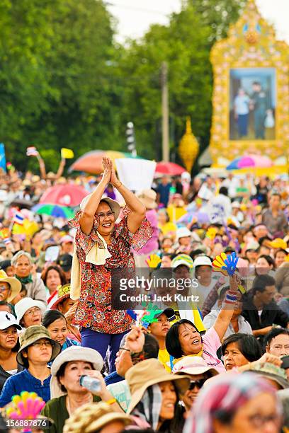People in the crowd dance and wave Thai flags during a large anti government protest on November 24, 2012 in Bangkok, Thailand. The Siam Pitak group,...