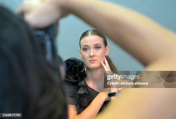 August 2023, Saxony, Dresden: Sarah Straube looks at the photographer during the photo shoot for the annual picture calendar of the Dresdner SC...