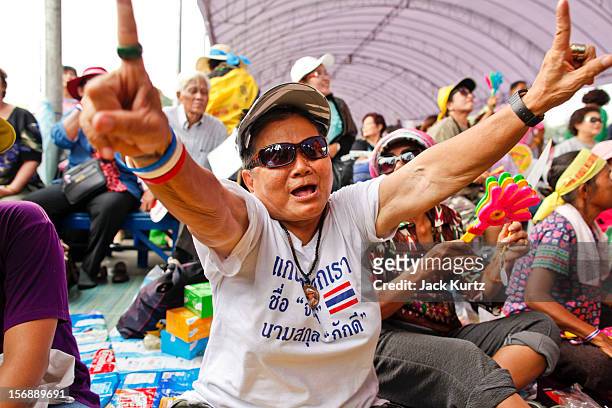 Woman cheers while Gen Boonlert "Seh Ai" Kaewprasit, leader of Pitak Siam, speaks during a large anti government protest on November 24, 2012 in...