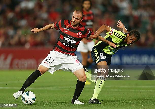 Jason Trifiro of the Wanderers is challenged by Jonathan Bru of the Victory during the round eight A-League match between the Western Sydney...