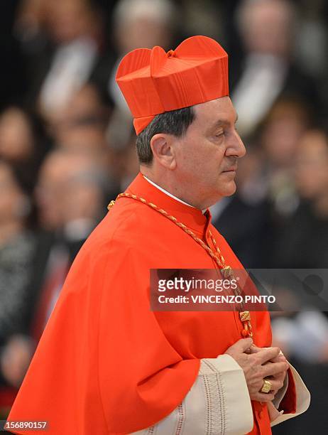 Colombia's Ruben Salazar Gomez, wearing his biretta hat, walks after Pope Benedict XVI appointed him as a cardinal during a ceremony on November 24,...