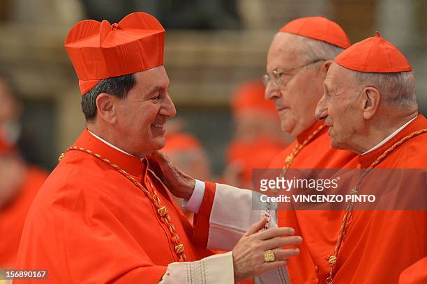 Colombia's Ruben Salazar Gomez wearing his biretta hat, is congratulated by other cardinals after Pope Benedict XVI appointed him as a cardinal...