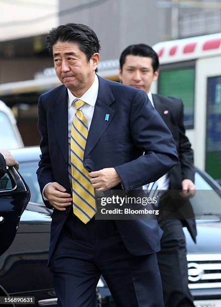 Shinzo Abe, Japan's former prime minister and president of the Liberal Democratic Party , left, arrives for a campaign rally for the Dec. 16 general...