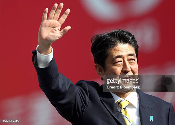 Shinzo Abe, Japan's former prime minister and president of the Liberal Democratic Party , waves during a campaign rally for the Dec. 16 general...