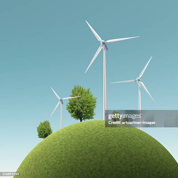 wind turbines on a green hill - energia sostenibile foto e immagini stock