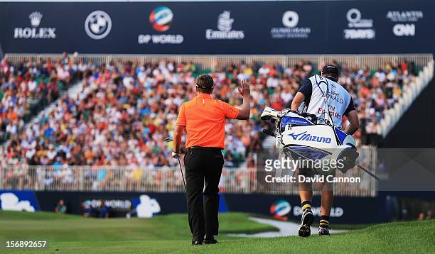 Luke Donald of England and his caddie John McLaren of England walk to the green before making a birdie at the par 5, 18th hole that extended his run...