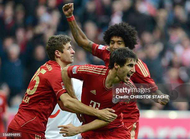 Bayern Munich's striker Thomas Mueller, Bayern Munich's Brazil defender Dante and Bayern Munich's Spainish midfielder Javi Martinez celebrate after...