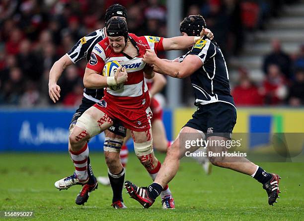 Tom Savage of Gloucester attempts to break free from the tackle of Ross Hamilton of Sale during the Aviva Premiership match between Gloucester and...