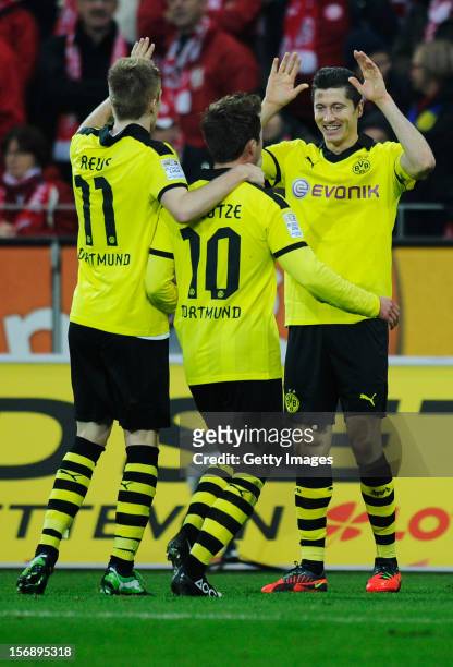 Robert Lewandowski of Dortmund celebrates his team's second goal with team mates Marco Reus and Mario Goetze during the Bundesliga match between 1....