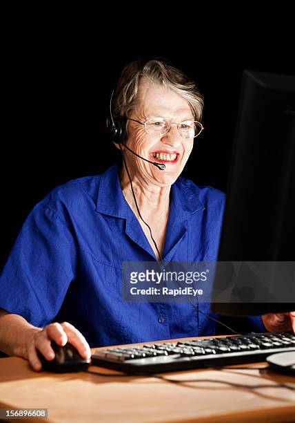 smiling senior keeps in touch via webcam - rea001 stock pictures, royalty-free photos & images
