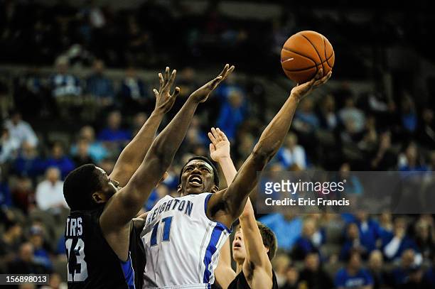 Andre Yates of the Creighton Bluejays shoots over William Truss of the Presbyterian Blue Hose during their game at CenturyLink Center on November 18,...