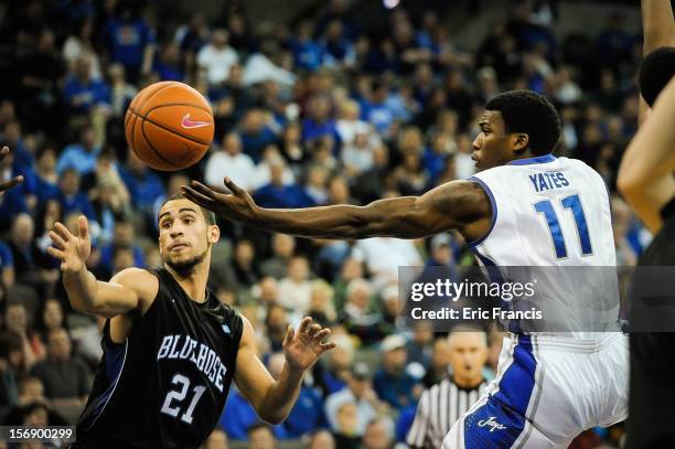 Andre Yates of the Creighton Bluejays drive the lane against Jordan Downing of the Presbyterian Blue Hose during their game at CenturyLink Center on...