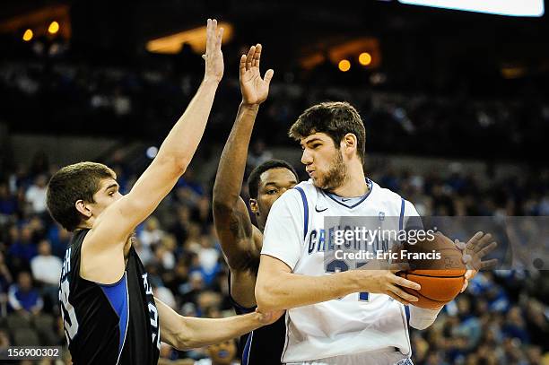 Will Artino of the Creighton Bluejays is guarded by Ryan McTavish and Joshua Clyburn of the Presbyterian Blue Hose during their game at CenturyLink...