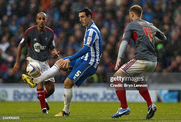 Lewis Dunk of Brighton and Hove Albion avoids Matt Mills of Bolton Wanderers during the npower Championship match between Brighton & Hove Albion and...