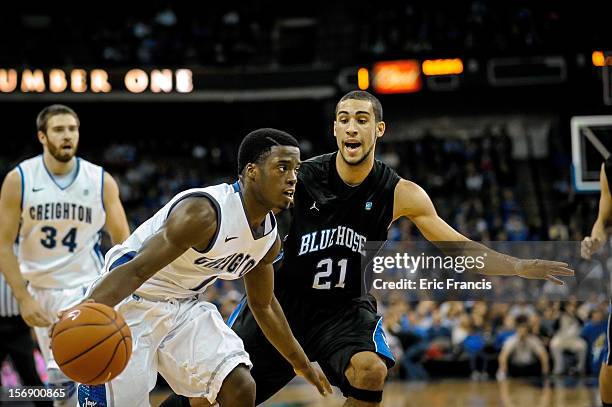 Austin Chatman of the Creighton Bluejays works his way around Jordan Downing of the Presbyterian Blue Hose during their game at CenturyLink Center on...