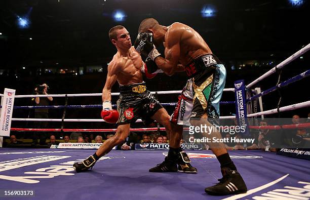 Scott Quigg in connects with Rendell Munroe during their Super Bantamweight bout at the MEN Arena on November 24, 2012 in Manchester, England.
