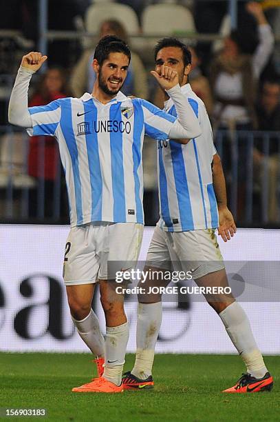 Malaga's midfielder Isco celebretes after scoring during the Spanish league football match Malaga CF vs Valencia CF on November 24, 2012 at Rosaleda...