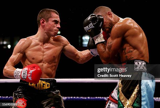 Scott Quigg in connects with Rendell Munroe during their Super Bantamweight bout at the MEN Arena on November 24, 2012 in Manchester, England.