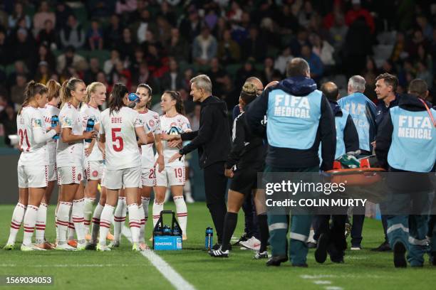 Denmark's coach Lars Sondergaard speaks with his players during the Australia and New Zealand 2023 Women's World Cup Group D football match between...