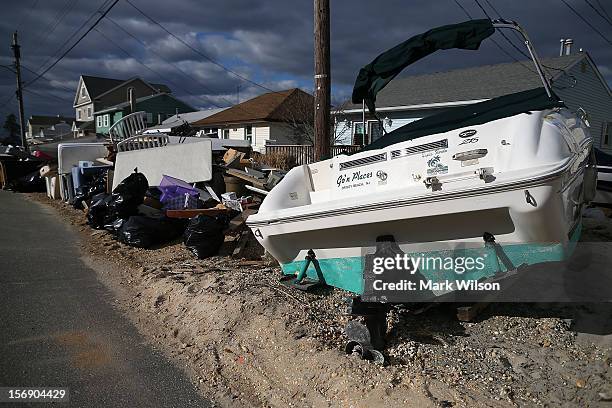 Trash is piled up in front of homes damaged by Superstorm Sandy, on November 24, 2012 in Ortley Beach, New Jersey. New Jersey Gov. Christie estimated...