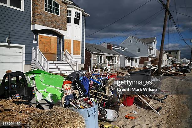 Trash is piled up in front of homes damaged by Superstorm Sandy, on November 24, 2012 in Ortley Beach, New Jersey. New Jersey Gov. Christie estimated...