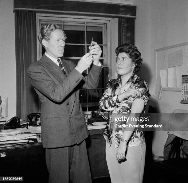 Dr Griffith Pugh , physiologist and mountaineer, prepares to give an injection to a patient named as Jo Gibbs, February 8th 1960.