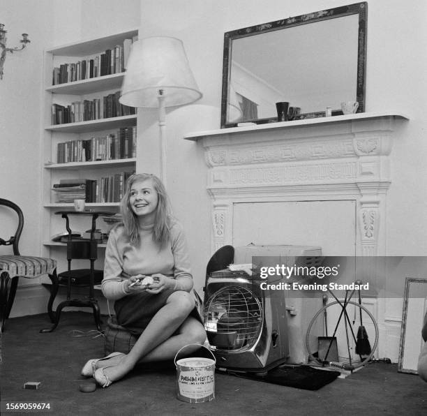 British actress Susannah York eating an apple in her flat in World's End, Chelsea, London, February 16th 1960.