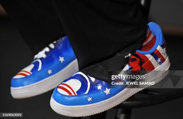 Singer Taboo, wearing a shoe featuring a picture US Democratic presidential candidate Illinois Senator Barack Obama, practices with lead guitarist...