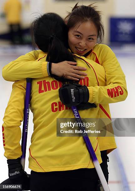 Qingshuang Yue and Yan Zhou of China celebrate their win over Japan during the Pacific Asia 2012 Curling Championship at the Naseby Indoor Curling...