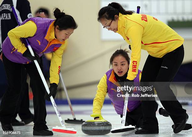 Qingshuang Yue of China delivers a stone during the Pacific Asia 2012 Curling Championship at the Naseby Indoor Curling Arena on November 25, 2012 in...