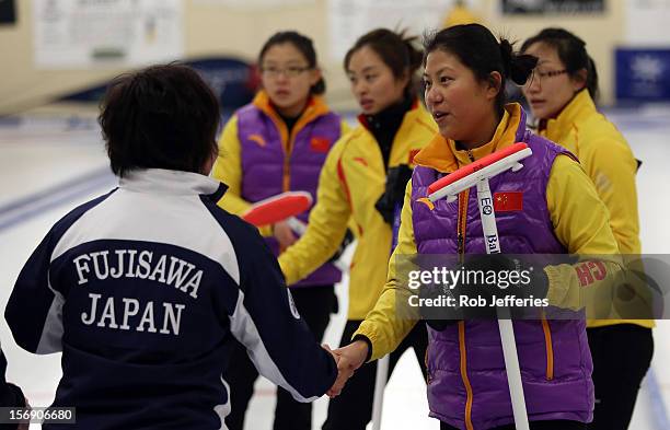 Bingyu Wang of China is congratulated by Satsuki Fujisawa of Japan after winning the womens final during the Pacific Asia 2012 Curling Championship...