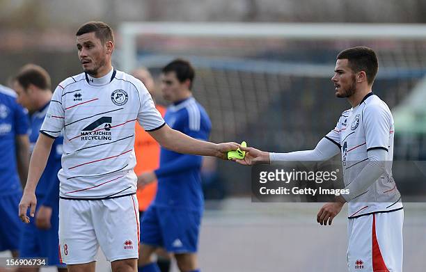 Alexander Maul of Seligenporten passes his captain's armband to team-mate Marco Wiedmann of Seligenporten after receiving a red card during the...