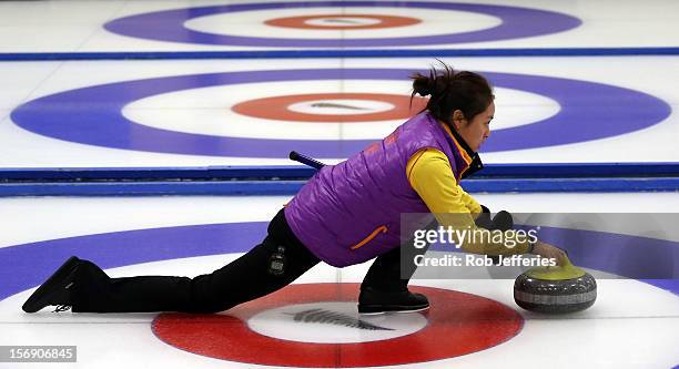Qingshuang Yue of China delivers her stone during the Pacific Asia 2012 Curling Championship at the Naseby Indoor Curling Arena on November 25, 2012...