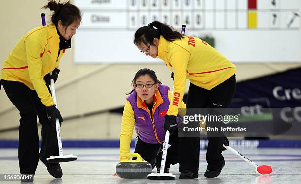 Bingyu Wang of China delivers her stone during the Pacific Asia 2012 Curling Championship at the Naseby Indoor Curling Arena on November 25, 2012 in...